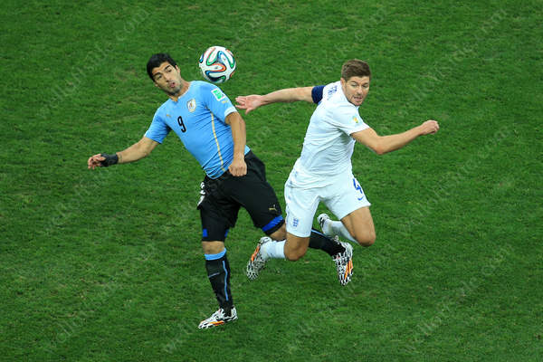 Luis Suarez of Uruguay battles with Steven Gerrard of England