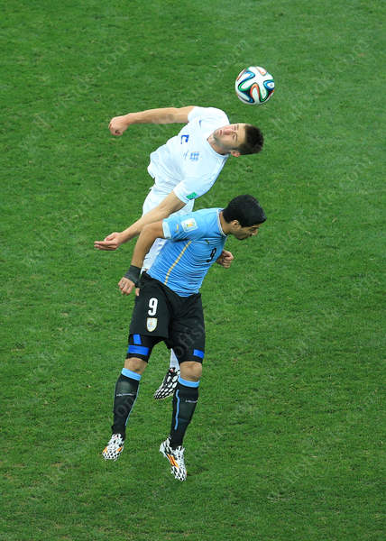 Gary Cahill of England competes with Luis Suarez of Uruguay